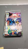Stack of comic books topped by Marvel X-Factor