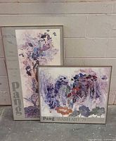 Both framed Pang posters side by side