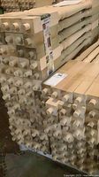 stacked bundles of square-ended poplar spindles