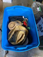 Blue tote containing hats, purses, other items