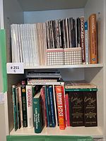 Full view of both shelves showing magazines on upper shelf and books on lower shelf