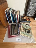 Group of 24 art and travel coffee table books, upright and stacked