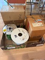 Overall lot with two boxed spools, one white cable spool, one green wire spool