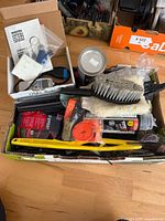 Overview of box showing multiple automotive accessories and supplies