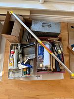 Group view of all items including extension pole, boxes with painting tools, metal toolbox