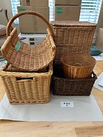 Five visible wicker baskets grouped together on floor
