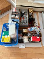 Overall lot view with glue gun, screws, tapes in trays and basket
