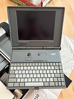 Open AST Advantage! NB 486SX/33 laptop showing keyboard, trackball and screen