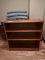 Front view showing three shelves and casters