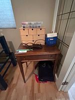 Fold-out sewing table with organizer, supplies and fabric underneath