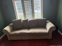 Front view of the beige 3-seater couch showing cushions, rolled arms, and fabric pattern
