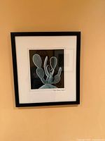 Square framed prickly pear cactus photograph on wall