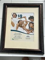 Dark wood-tone 11x14 frame with cream mat