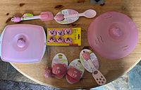 Full layout of all Piggy Wiggy pink silicone kitchen items on table