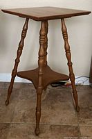 Full view of oak parlor table showing legs and lower shelf