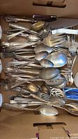 Box of assorted silver-plated spoons, forks, knives, shears