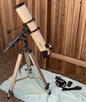 Full view of telescope on tripod with accessories laid out