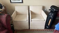 Front view of both beige upholstered side chairs