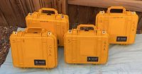 Four yellow Pelican 1400 cases closed showing exterior condition and markings