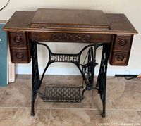 full view of Singer treadle cabinet with drawers and base
