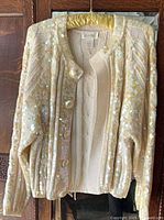 Full view of Destinee sequin cardigan on hanger