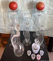 Group view of all candlesticks, both decanters, shot glasses