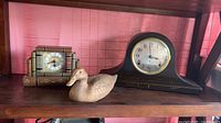 All three items on shelf: Seth Thomas mantel clock, decorative book clock, carved wood duck
