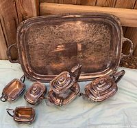 Group shot showing all eight Wallace silver-plated pieces including tray, teapot, creamer, sugar bowl and four covered dishes