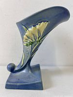 Right-side view of Roseville Lily vase showing lily motif and pedestal base
