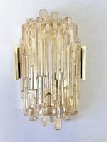 Front view of textured champagne art glass wall sconce