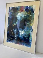 Front angled view of framed abstract artwork showing colors and mat