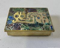 Top view showing brass and stone mosaic lid with stylized motif