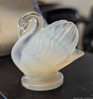 Front angled view of Sabino opalescent glass swan on pedestal base
