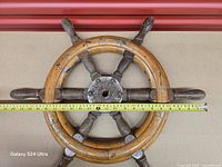 Front view showing full wheel and measuring tape across diameter