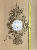 Front view of brass Buney wall clock with tape measure for scale