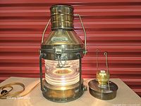 Front view of brass Anchor lantern wired for electric, oil font beside