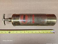 Full extinguisher with tape measure showing length