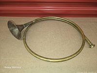 Full view of coiled brass hunting horn