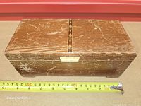 Top view showing geometric inlay and measuring tape indicating around 22 cm length