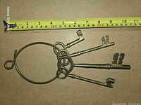 Keys laid flat with measuring tape for scale