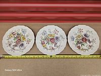 Three Johnson Bros Sheraton salad plates top view with measuring tape