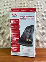 Front of sealed APC SurgeArrest box showing model details and features