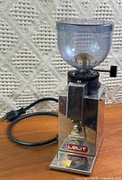 Full view of Lelit Fred grinder showing stainless body, hopper, power cord