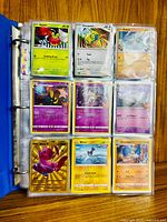 Open binder showing page with Applin, Dunsparce, Golett and foil cards