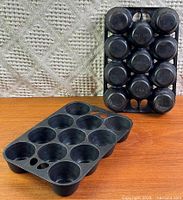 Both muffin pans, Griswold standing, unsigned lying flat