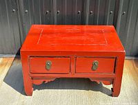 Front view showing two drawers, brass pulls, carved apron, overall form