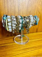 Full view of approximately 30 assorted bracelets and bangles on display stand