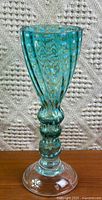 Full view of turquoise pull-spotted footed glass vase