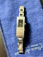 Front view of Fendi 3300L watch showing slim rectangular case, black dial, bracelet