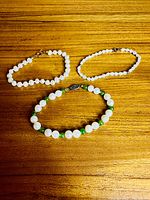 All three pearl bracelets laid flat showing design and clasps